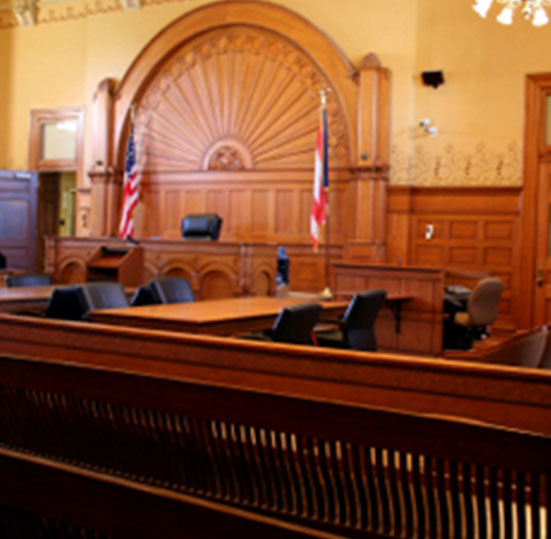A courtroom with a judge 's bench and the jury box.